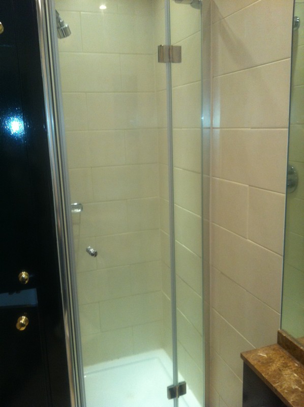 Frameless glass shower enclosure with chrome fittings in Wallington