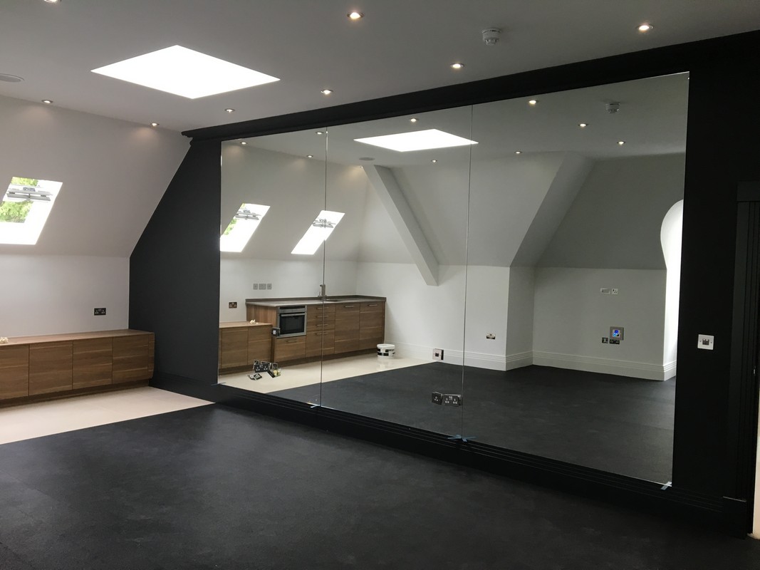 Frameless glass wall dividing loft conversion in Wallington