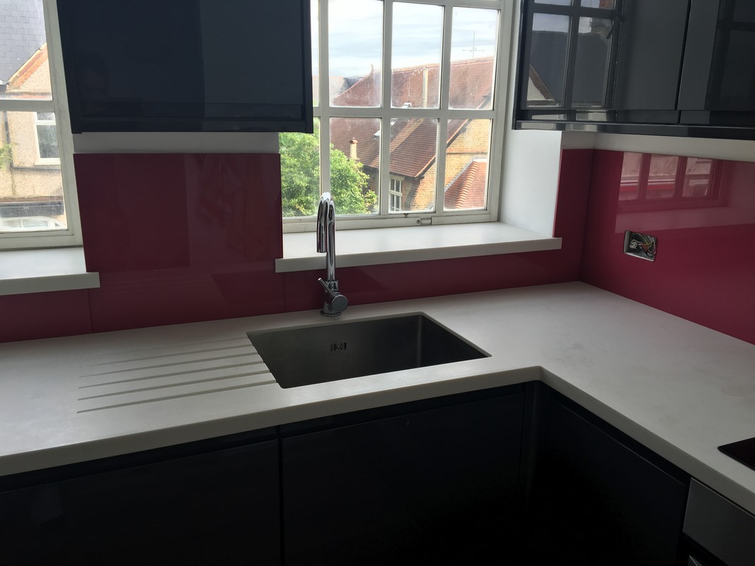Deep plum coloured glass splashback in modern Wallington kitchen