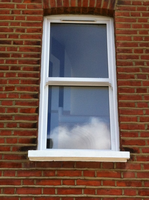 uPVC sash window on Victorian red brick house in Wallington